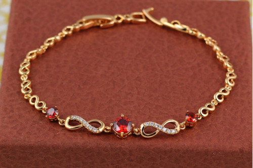 Браслет Xuping Jewelry вісімки з трьома круглими червоними каменями по центру 17 см золотистий
