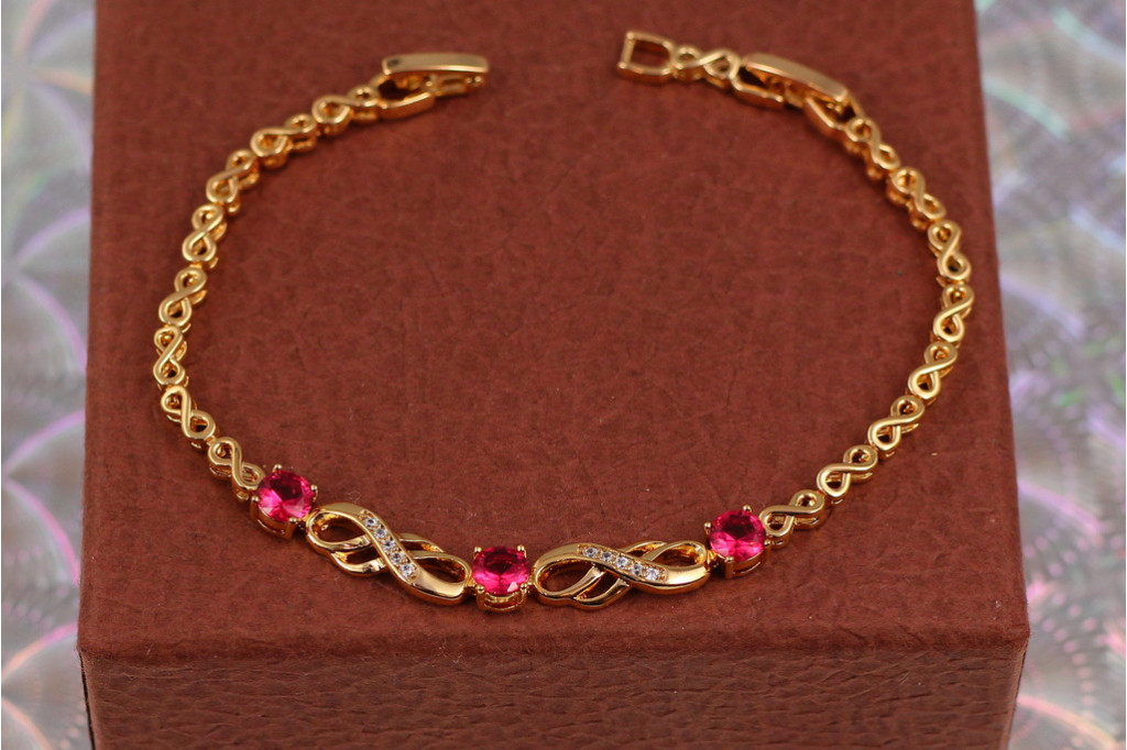 Браслет Xuping Jewelry вісімки з трьома круглими малиновими каменями у центрі 19 см 6 мм золотистий