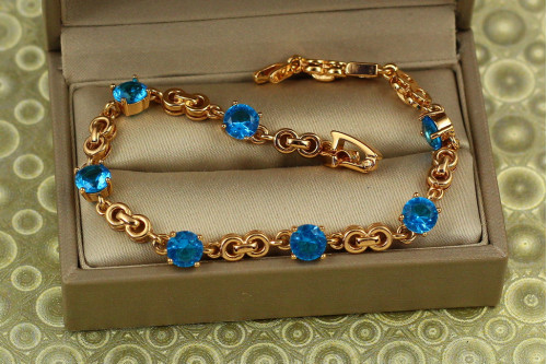 Браслет Xuping Jewelry Фуэте с голубыми камнями 17 см 6 мм золотистый